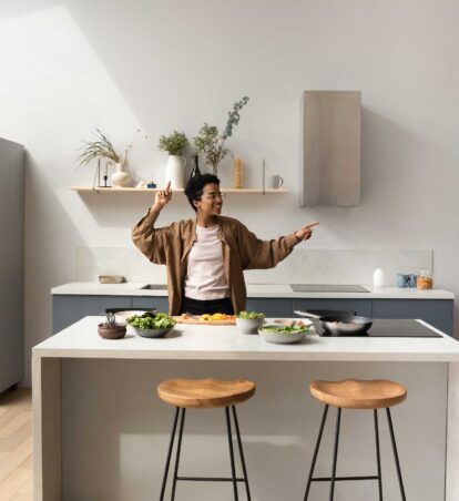 a person dancing in their kitchen