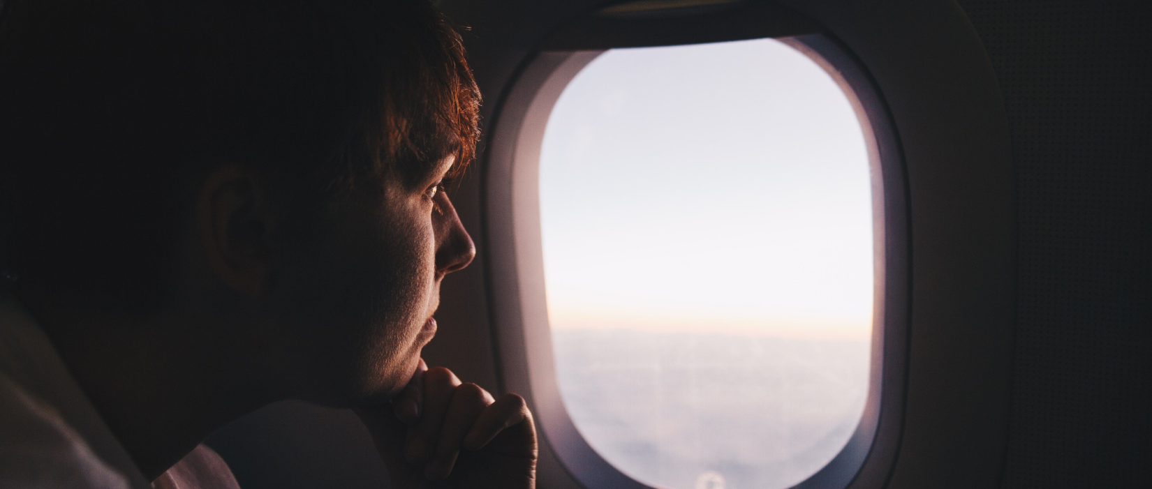 person looking out an airplane window