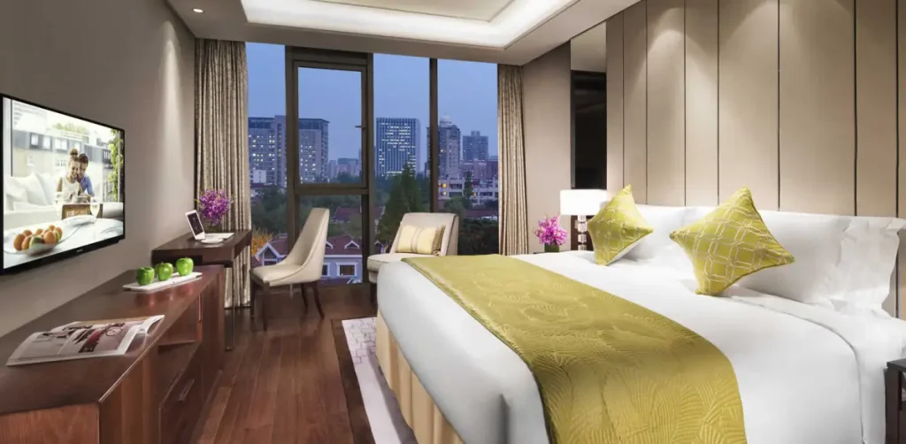 Contemporary bedroom with a great outdoor view of a skyline at night.