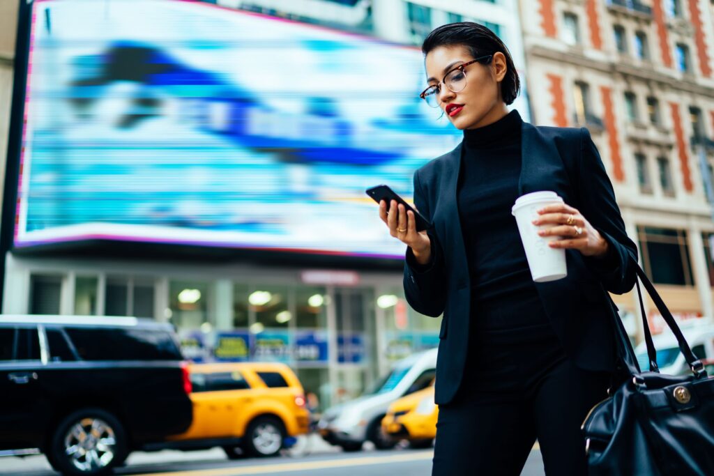 Person on phone in congested city street 