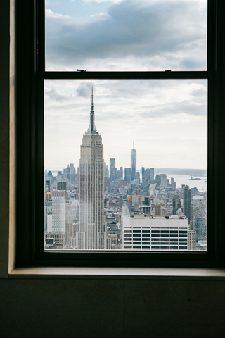 Skyline view of NYC from a window.