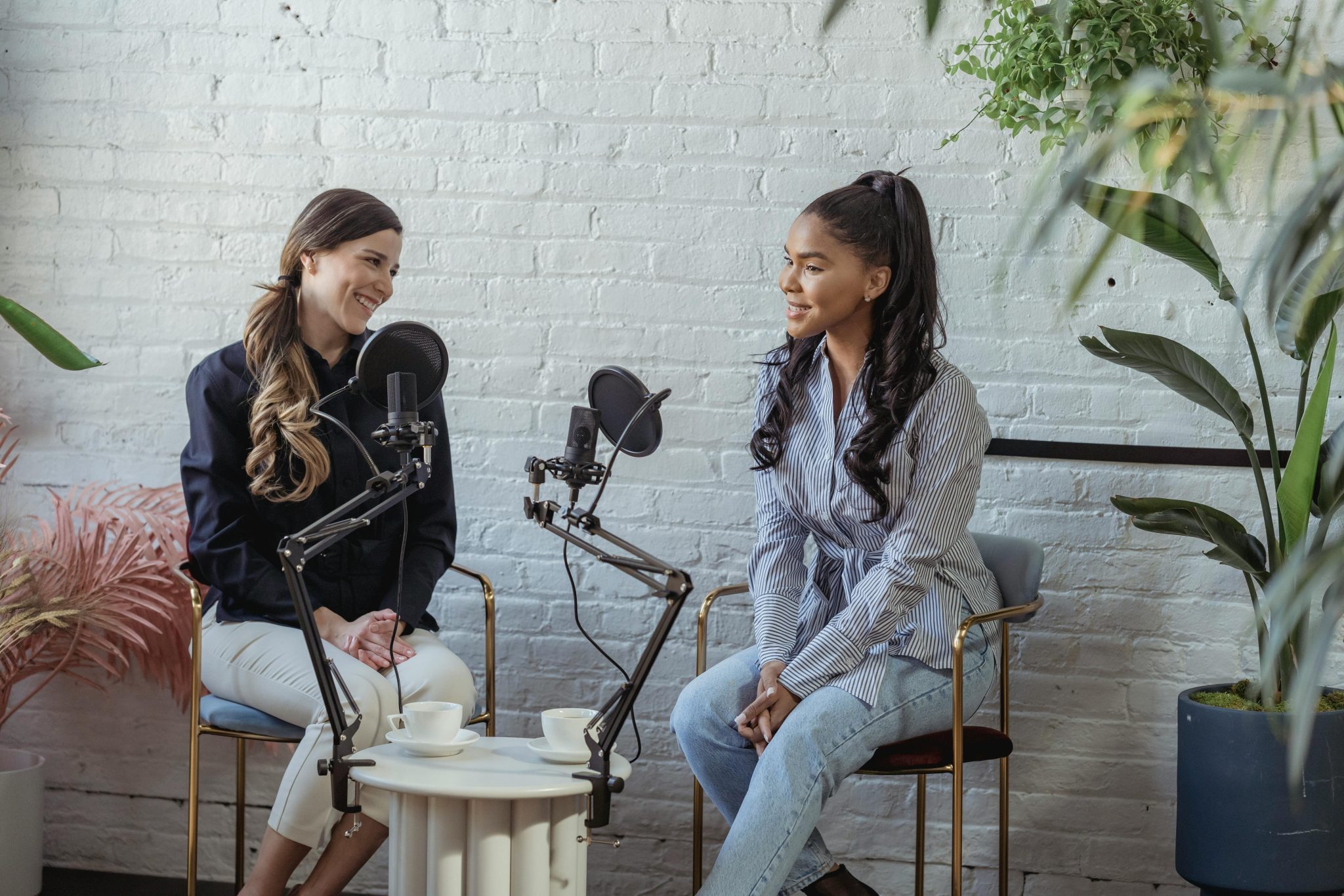 Two women speaking on a podcast