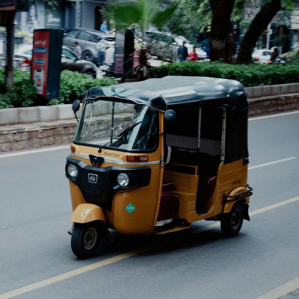 Auto-rickshaw in the middle of the road.