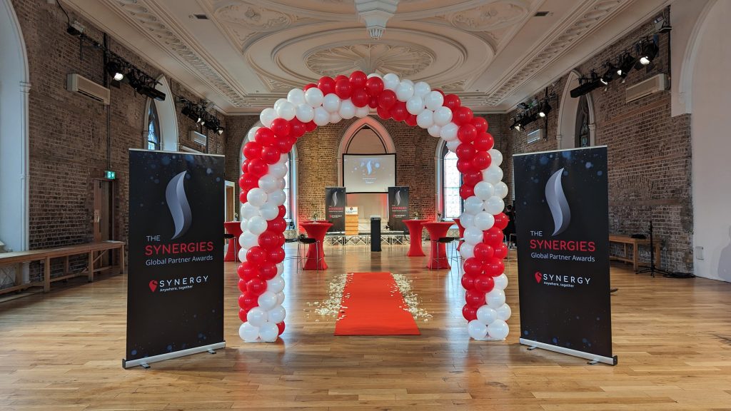 Balloon arch decor with red carpet.