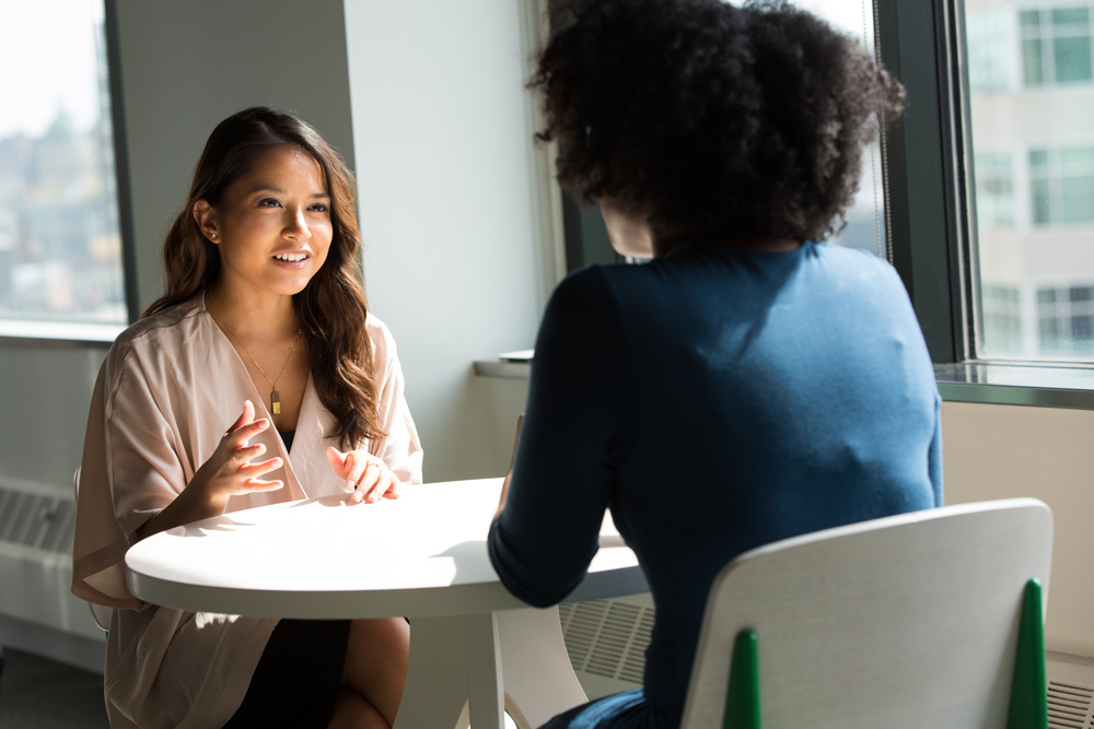 Two people consulting.